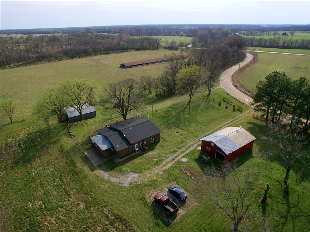 Escape to your private retreat of peace and convenience with this 3-bedroom, 2-bathroom home nestled on 21.76 picturesque acres. The property features a mix of open pasture and mature woods, with a refreshing clear water creek (Beaty Creek) running through the landscape—ideal for nature lovers and hobby farmers alike.Enjoy outdoor living on the covered porch and the garden area, or take advantage of the detached 2-car garage/metal shop building—perfect for projects, storage, or extra parking. All this in a private country setting, just 35 minutes from both Bentonville, AR and the Northwest Arkansas Regional Airport (XNA). Whether you're looking for a quiet retreat, space to grow, or a hobby farm close to town, this property offers the best of both worlds.