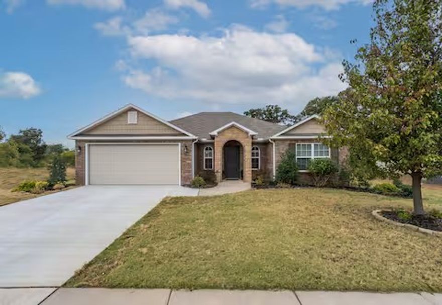 Welcome Home! This gorgeous 4-bed, 2-bath (former model) home in the highly desirable Lakewood community offers a spacious and inviting layout with stylish finishes throughout, plus a 2-car garage with *climate control* for added flexibility. Step out back to a covered patio overlooking a large backyard that backs directly to a neighborhood walking trail, providing a peaceful setting and easy access to outdoor enjoyment. Currently operating as a successful short-term rental, this property offers flexibility whether you're seeking an investment opportunity or the perfect place to call home. Conveniently located near XNA Airport, top-rated schools, and great restaurants, this home provides easy access to everything Northwest Arkansas has to offer. Walk through the door and start picturing your next chapter here.