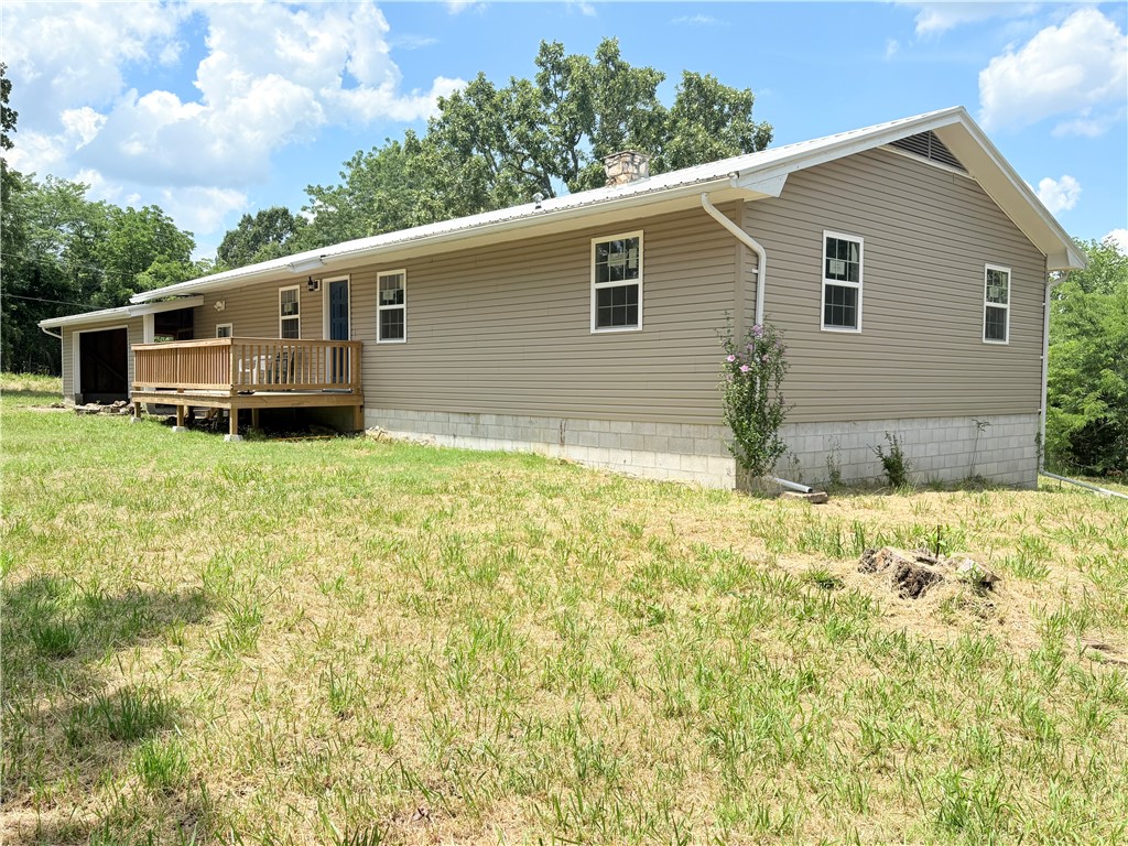 Enjoy quiet country living near Bull Shoals Lake! This updated 3BD/2BA home on 1.18 unrestricted acres features new hickory flooring, fresh paint, updated lighting, new windows, and PEX plumbing. Includes a bonus room, unfinished basement with bath, and garage-style outbuilding. All-electric with private well. Just 15 mins to Branson and 5 mins to lake access! Water intrusion has been observed in the basement during periods of heavy rain, likely due to exterior drainage. The property is being sold as-is, with no repairs or warranties expressed or implied. Buyers are encouraged to conduct any inspections they deem necessary.
