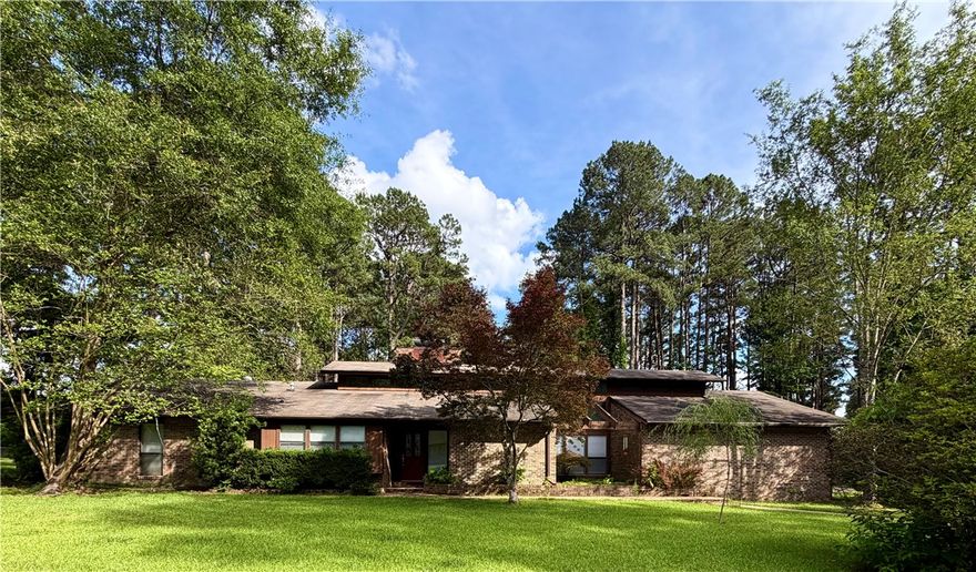 Fantastic 3 BR with office AND bonus area, 2.5 baths. Kitchen has many updates including gorgeous white cabinets with granite counters, and there’s tons of cabinet storage and counter space! Kitchen island has JennAire electric glass cooktop and there’s a separate electric JennAire oven with built-in microwave. Dishwasher is almost new. Brand new stainless steel farm sink with new Delta faucet and plumbing. Huge walk-in pantry with freezer space and cabinetry, large eat-in kitchen. Formal dining room, large office and tons of unique windows and lighting! This home has character and you’ll know it when you step inside! The grand fireplace is brick(two sided to the soaring ceilings). Vaulted kitchen, massive den/living room with built-ins. Owner has closed in porch to create a sunroom perfect for your plants or coffee/tea (heated/cooled space increased). New flooring in master bed/bath/closet, living room. Master is huge with fantastic walkin closet and brand new walk-in shower! Laundry room is unique and incredible!