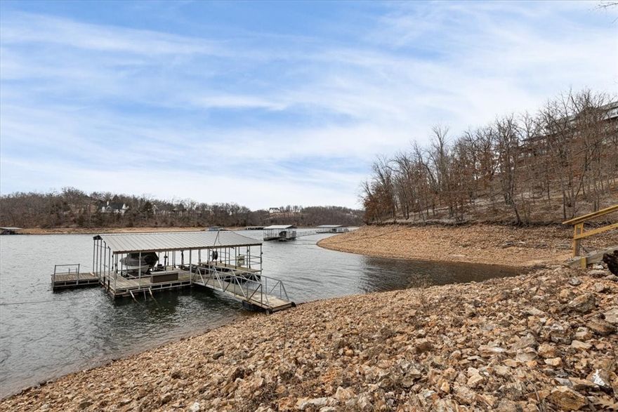 Beaver Lake Front home with private 2 stall boat dock (with lifts) and swim platform!  Great Cove, fantastic lake location, private road off of Coose Hollow Lane. Endless opportunities with the flexible space this home offers! Primary suite is huge with a private deck and spa-like bathroom. 
 Home features two full kitchens - could be an in-law suite or potential to use as two units for air BNB, or a rental. (two HVAC units with own meters).  
Huge loft, soaring vaulted ceilings, tons of character and charm, attic storage, 
Two barns - one boasts a two-car garage, both are great for shop and/or to park trailers, equipment, utility vehicles, etc. 
Nature abounds in this private oasis of over 7 acres! This is what lake living is all about!  There are 2 parcels with this listing!  One parcel is across Coose Hollow Lane (3.02 acres)
There is a path and cart path to the dock. Handicap accessible permit from Corps needed to use cart path all the way to dock.
Less than 20 minutes to Rogers!