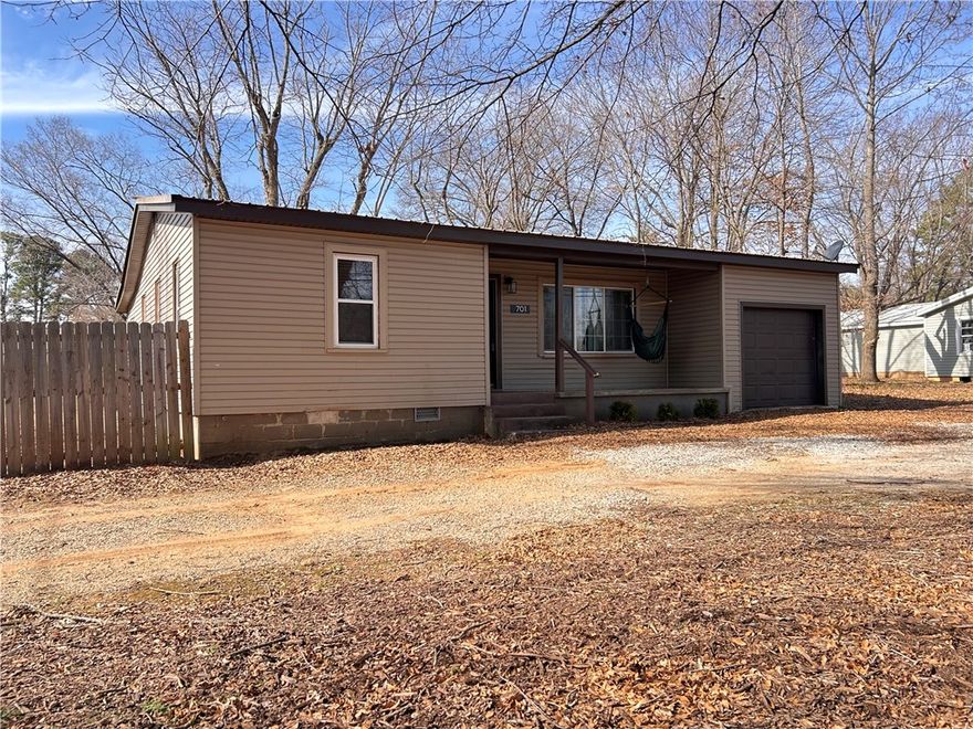 Welcome home to this charming Pea Ridge property offering +/- 1,094 SF on a generous +/- 0.38 acre lot. This well laid out home features 3 bedrooms and 1 bathroom, complemented by hardwood floors throughout. The eat-in kitchen provides a comfortable space for everyday living, while the additional sitting room and sunroom add flexible areas for relaxing, entertaining, or working from home. Practical features include a 1 car garage, dedicated laundry room, and a fully privacy fenced backyard, ideal for outdoor enjoyment. Washer, dryer, stove, and refrigerator all convey, making this a move-in ready opportunity. The location is a standout. Situated near the new Pea Ridge Community Park, the home is just minutes from Pea Ridge schools and less than half a mile from the Highway 72 intersection, offering convenient access to Bentonville, Rogers, and everything Pea Ridge has to offer. This is a great opportunity for those seeking comfort, convenience, and a strong location.