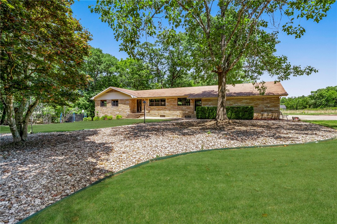 Unique Property Alert! This home is almost 2 houses in 1 sitting on 0.66 of an acre! Main level of home has an open floor plan, large living room, spacious kitchen with custom cabinets, utility room, master suite with WIC + 1 other bedroom. Fully finished basement features large open living room/bonus space, FULL kitchen, 2 bedrooms & a storage/workout room. New paint, fixtures and flooring throughout. 2 miles from 71B, 2 miles to downtown Rogers, convenient to Hwy 265 to Springdale/Fayetteville. 100% financing RD loan available-$0 down payment. Agent owned.