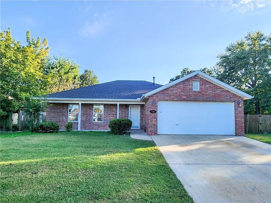Discover this move-in ready home, purchased by the seller less than six months ago and now relocating out of state. Inside you'll find a bright, open living room with vaulted ceilings, fresh paint, and new flooring throughout. The eat-in kitchen flows into the living area, centered around a cozy fireplace, and a brand-new, beautiful sunroom with vaulted ceiling and abundant windows expands the living space and fills the home with natural light. Outside features include a covered porch, back patio, two-car garage, and a large fenced backyard—perfect for play or relaxation. With a brick front, attractive curb appeal, and a quiet neighborhood near schools, parks, and local amenities, this home combines recent updates with small-town charm.
