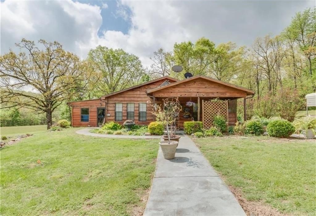 This is a gorgeous cedar complex with tons of landscaping and waterworks galore. Has extra barn garage, well house & storage building all cedar to match the house. Almost 2700 SF with 3 bedrooms, 3 baths, 2 living areas with fireplace in each, nice kitchen, electric range & 2 ice maker connections. Very energy efficient. Nice master suite. Patio to sit out & enjoy the view. Additional acreage available.