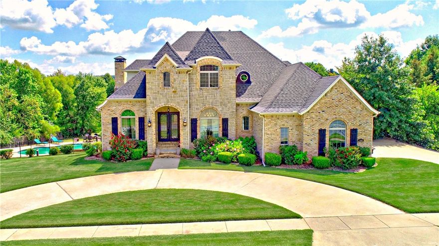 Nestled on a spacious 0.9-acre lot in the desirable Overton Park Subdivision, this three-story, 5,245 sq ft residence combines luxury and comfort with its 5 bedrooms, 4.5 bathrooms, and elegant wood flooring throughout! The expansive living area boasts a large front office, an elegant formal dining room, and a spacious eat-in kitchen, ideal for entertaining. The impressive master suite includes a spacious bathroom, ample closet space, and a private balcony that overlooks the beautifully landscaped backyard, complete with an in-ground pool, large back deck, covered patio and a versatile workshop in the fourth garage. The home's walk-out basement turns the backyard into an entertainment paradise, complete with a wet bar and expansive area suitable for a home theater, game room, or mother in-law suite. This property seamlessly blends privacy with functionally making it an outstanding choice for those searching for luxurious yet comfortable living in Fayetteville, AR.