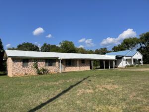 2 Homes, 2 Families, 2 investment opportunities all in one. Do the work and reap the rewards on this 2 residential homes on 2.4 acres in Clarksville city limits. The first home features a 3 bed 2 bath 1689 sq ft home with unique features that makes it stand out. Large living room, built in gun safe, open kitchen dining area and 2 car carport. The second home features a 1 bed 1 bath 728 sq ft home with lots of opportunity. Close to town but lots of room to spread out. 2 outbuildings, 2 back patios, and another carport in the back. So much to offer call for all the details. Both homes will be sold together, no option to buy separately.