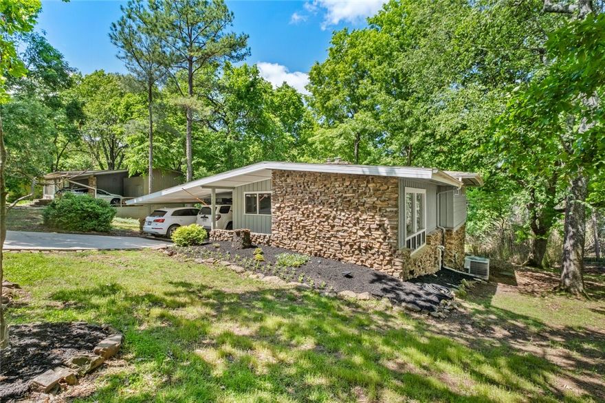 Fantastic East Fayetteville home with loads of upgrades and ready for you. Open airy floor plan with wood accents, gorgeous decks, and screened in porch make entertaining easy. The charming kitchen and wood burning fireplace are perfect for gathering around a home cooked meal. Four spacious bedrooms and 2 full baths suit a variety of needs. This location makes exploring Fayetteville safe and easy as it is only moments away from the Mission Boulevard Trail, Root Elementary School, shopping and dining. This is the one you've been waiting for! This home blends modern elegance with natural tranquility—don’t miss your chance to make it yours!
