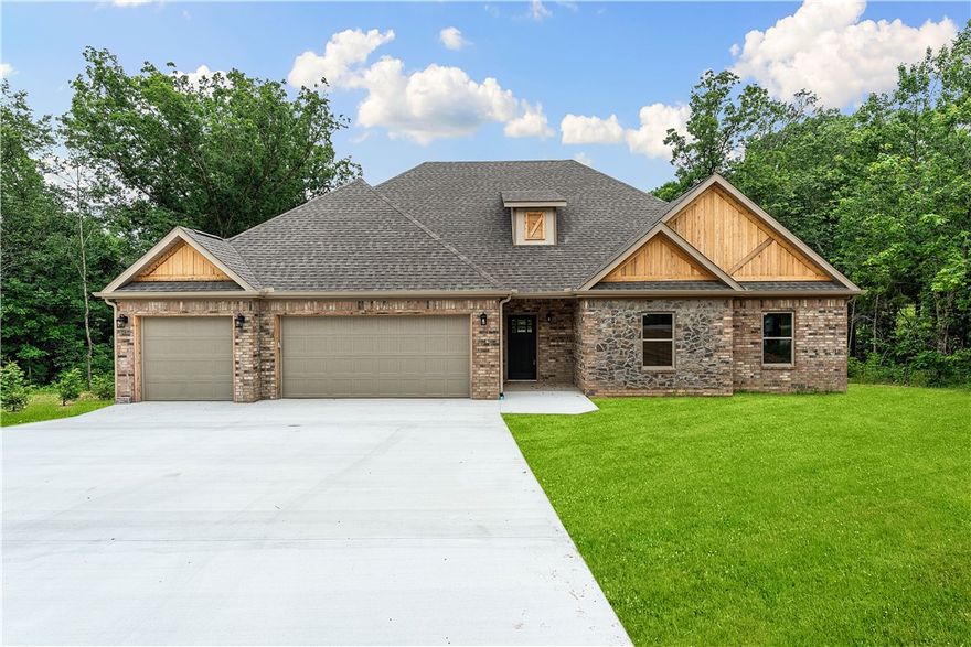 Stunning New Construction in Bella Vista! This beautifully crafted 3-bedroom, 2-bath home with an office/study/misc. Bonus Room is conveniently located just minutes from I-49 and Highway 72. Step inside to find rich 3/4 hickory plank wood flooring throughout, 9-foot ceilings (10-foot in the living and kitchen), and a dramatic floor-to-ceiling electric fireplace. The custom kitchen features built-in custom cabinetry, a generous island, quartz countertops, a walk-in pantry, and cased windows in the living and breakfast areas. The luxurious master suite boasts a large walk-in closet, gorgeous walk-in shower, and a jetted tub. Enjoy peaceful views from the covered concrete back patio with stylish metal and cable railing. A three car garage, with you in mind! Thoughtfully designed with foam insulation, insulated garage and garage doors, crown molding, cedar gables, and brick-and-stone accents—this home is packed with extras that deliver comfort, efficiency, and timeless style.