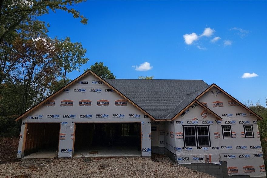 Stunning 2890 sq ft all brick home on a private .47 acre lot at the end of a cul-de-sac with a seasonal view overlooking Loch Lomond. 4 Beds (3 on main floor) + a bonus, a pocket office, 3 and a half baths, and a luxurious primary suite with direct deck access, a freestanding tub, and an expansive bath. A vast open living/dining/kitchen with vaulted ceilings, a fireplace, quartz counters, and high-end finishes. A 52' long X 12' deep rear deck with a 20X12 covered area, great for outdoor gatherings. The 3-car garage connects the mudroom and pantry, with Pella windows and tasteful designer details and Fridgidaire Gallery appliances.
