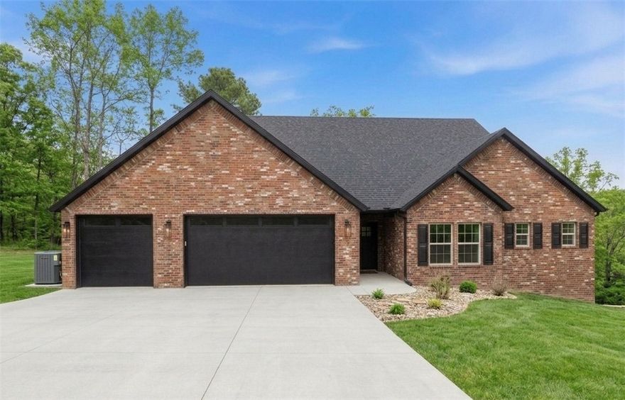 Stunning 2890 sq ft all brick home on a private .47 acre lot at the end of a cul-de-sac with a seasonal view overlooking Loch Lomond. 4 Beds (3 on main floor) + a bonus, a pocket office, 3 and a half baths, and a luxurious primary suite with direct deck access, a freestanding tub, and an expansive bath. A vast open living/dining/kitchen with vaulted ceilings, a fireplace, quartz counters, and high-end finishes. A 52' long X 12' deep rear deck with a 20X12 covered area, great for outdoor gatherings. The 3-car garage connects the mudroom and pantry, with Pella windows and tasteful designer details and Fridgidaire Gallery appliances.