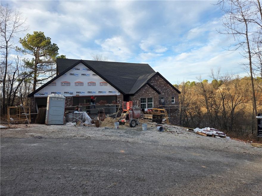 Stunning 2890 sq ft all brick home on a private .47 acre lot at the end of a cul-de-sac with a seasonal view overlooking Loch Lomond. 4 Beds (3 on main floor) + a bonus, a pocket office, 3 and a half baths, and a luxurious primary suite with direct deck access, a freestanding tub, and an expansive bath. A vast open living/dining/kitchen with vaulted ceilings, a fireplace, quartz counters, and high-end finishes. A 52' long X 12' deep rear deck with a 20X12 covered area, great for outdoor gatherings. The 3-car garage connects the mudroom and pantry, with Pella windows and tasteful designer details and Fridgidaire Gallery appliances.