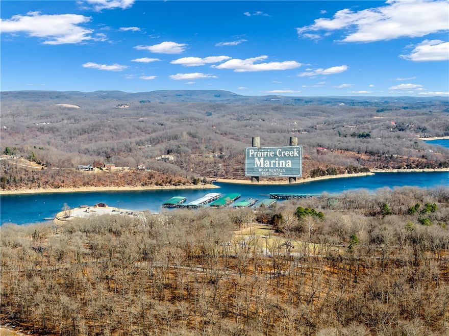 Welcome to 9251 Grimes Drive, where lake life meets comfort on over a third of an acre. This 4-bed, 3-bath ranch offers 3,166 square feet across two levels. The main floor features an open layout with a spacious living room, formal dining, and eat-in kitchen with quartz counters. The finished walk-out basement includes a generous game room and wet bar, perfect for entertaining. Enjoy wood and tile flooring throughout. The wooded lot provides privacy and scenic views, with a covered patio and deck for outdoor relaxation. Just minutes from Prairie Creek Marina and Beaver Lake, this property offers the perfect blend of recreation and convenience. Enjoy easy access to golfing, boating, fishing, and lake life right at your doorstep, while being less than 5 miles from downtown Rogers with its shopping, dining, and entertainment. Whether you're looking for a weekend retreat or full-time residence, this location combines natural beauty and city convenience in one ideal spot.