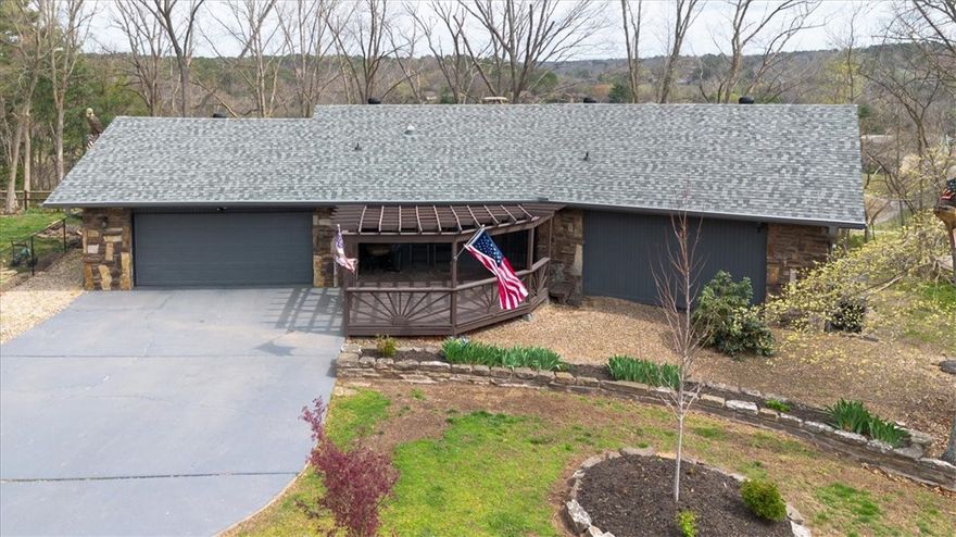 This charming Bella Vista home offers beautiful golf course views from both the covered and open areas of the expansive deck. Lovely curb appeal with a long driveway and pergola covered entry. Inside you will find wood beams, natural stone fireplace, exposed brick, wood ceiling, and large open spaces! 2 bedrooms with a 3rd bedroom/game room combination that includes built-ins and Murphy bed. A gem of a home that is everything but cookie cutter!