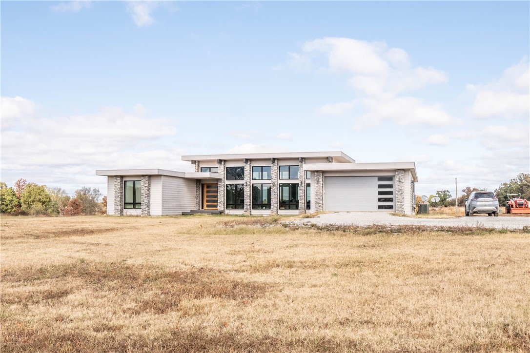 This modern 4-bed, 2.5-bath home sits on 9.89 private acres with a shared pond and detached 1800sqf metal shop. The open interior features 13-foot ceilings, a gourmet kitchen with quartz counters, and luxury finishes throughout. No HOA or restrictions giving you the freedom to use the property as you wish.