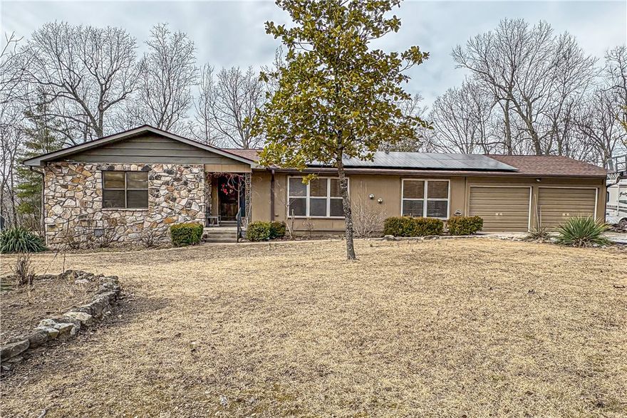 Tucked away at the end of the road, this private 15-acre retreat offers the perfect blend of seclusion and convenience, bordering Corp of Engineer’s land where you can pull your canoe or kayak right to the lake from your back yard. Walking trails throughout the property.  This 3-bedroom, 2 bath home features a spacious layout with an attached two car garage plus a detached garage/shop ideal for hobbies, storage, or projects. Enjoy energy efficiency with solar power, and encapsulated crawl space.  Whether you are looking for a peaceful homestead, hunting getaway, or room to roam, this property delivers space, sustainability, and unmatched privacy.