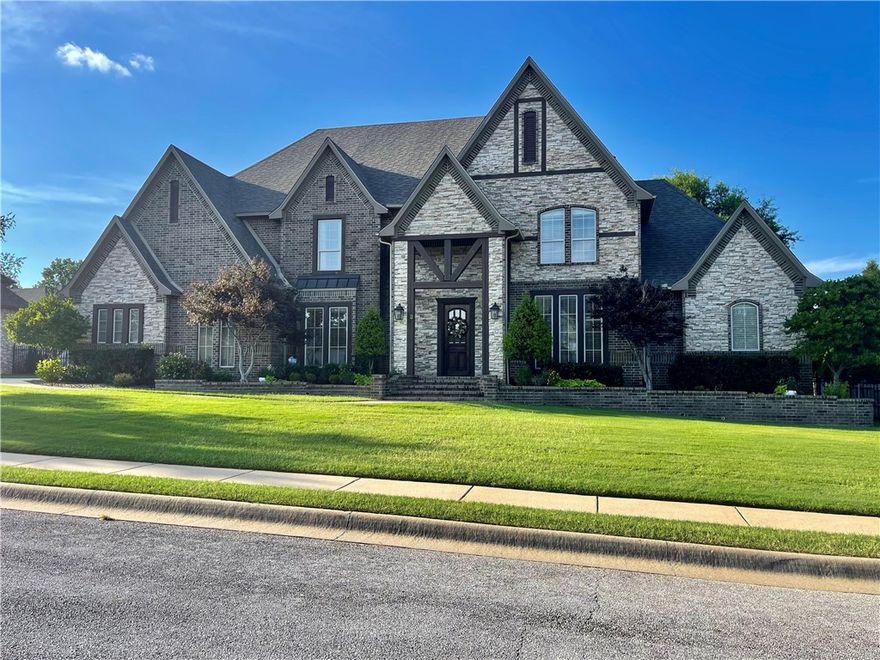 Relax on the large, covered porch while enjoying the view of the gunite headed pool (heater 2 months old equip conveys) with diving board.  Just a click of a button, your pool is covered automatically, and your friends can retreat to the Guest House or join you in the heated spa (conveys).   The guest house is comfortable year-round with a full bath including a shower (Funiture conveys) .  Besides 4-bedroom 3 bath with a dining room, eat in kitchen and office, this home offers GE induction cooktop (better than electric or gas), double oven (one is conviction), new roof 2022, commercial ice maker 2023, newly painted kitchen, family room, halls and laundry.  Kitchen boast tons of storage, quartzite and quartz new countertops and a dazzling, modern painted island that stores the microwave.  Don't forget to open the two doors upstairs to see all of the easy access storage.  DaCor High End Refrigerator, Washer and Dryer are negotiable.   Two means of entry to I-40 or 71.  You are 15 minutes from Rogers or Fayetteville