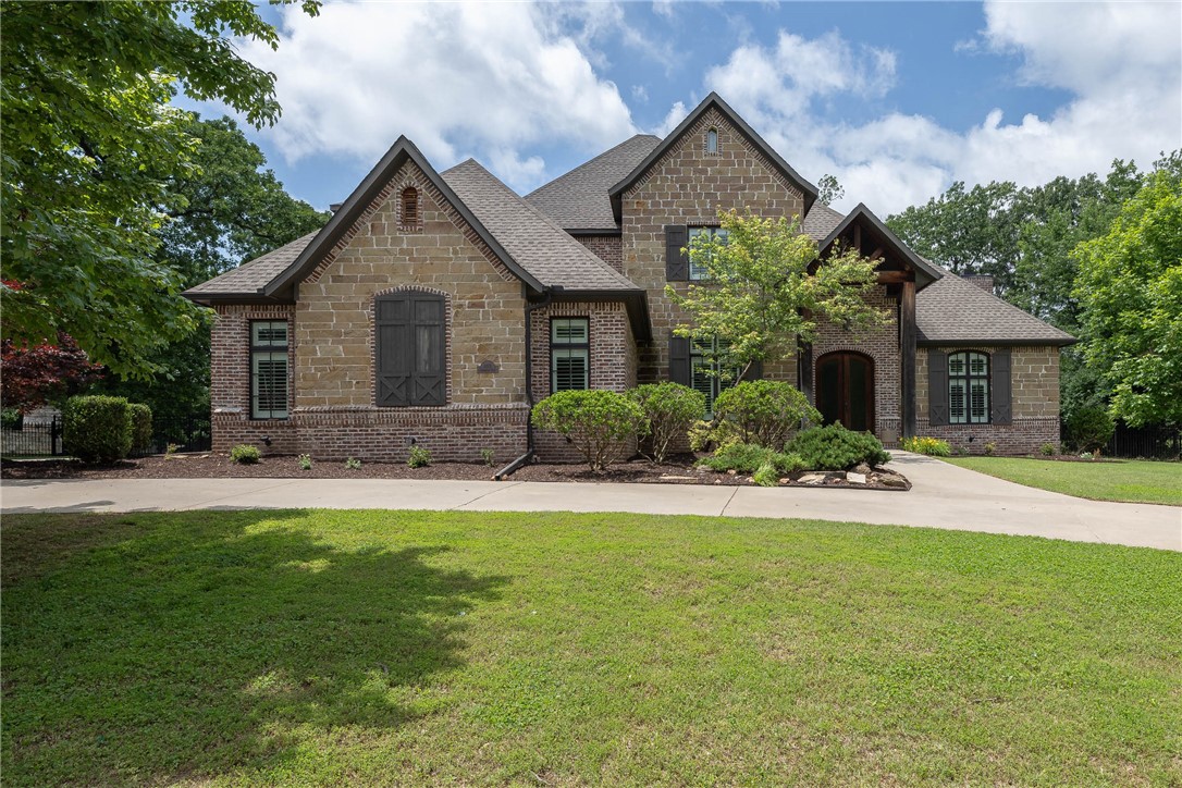 Nestled within the exclusive gated community of Clear Creek, this beautiful residence invites you to experience upscale living at its finest! Step inside to discover a formal dining room, dedicated office, & spacious living room with gas fireplace, perfect for gatherings. The gourmet kitchen is a chef's delight, showcasing granite counters, stainless appliances including double oven, & walk-in pantry, while the eat-in kitchen area offers a casual dining space. The butler's pantry ensures effortless entertaining. The Owner's suite is a sanctuary offering a private bath, double vanity, whirlpool tub, & walk-in shower with dual heads. Additional upstairs living spaces include a bonus room, media room, & three bedrooms. Outside you'll find a covered patio with an outdoor fireplace, perfect for year-round enjoyment. Conveniently located with easy access to I-49, this home combines luxury living with practicality. Schedule your private tour today and discover the exceptional lifestyle that awaits you in Clear Creek.