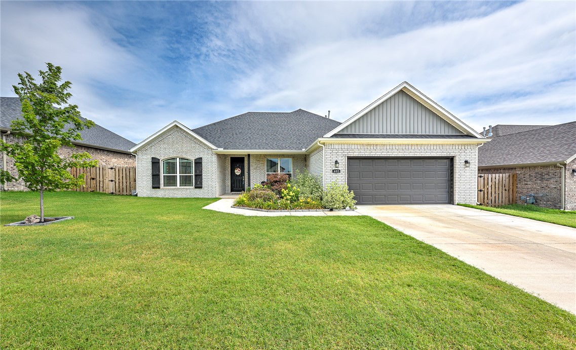 Nestled in the serene subdivision of Engle's Mill, this charming single-story brick home offers 1983 sqft of modern living space in one of the fastest-growing communities in Northwest Arkansas. Built in 2022, it features 3 bedrooms, 2 bathrooms, an additional office & a split floor plan for added privacy. The kitchen boasts a gas cooktop, oven, microwave, dishwasher, & ample pantry space. The living areas are adorned with ceramic tile flooring & large windows that fill the home with natural light. Outside, you will find a cool covered patio, a wood privacy fenced-in backyard, & a concrete driveway leading to a 2 car garage. Amenities like ceiling fans, walk-in closets, attic storage, and washer/dryer connections enhance comfort and convenience. Situated near schools, sports complexes, multiple restaurants, & retail options, this home includes upgrades like level 2 brick, quartz countertops, tile flooring, an estate kitchen re-configuration, Arcadia light fixtures, a no-divider stainless steel sink, & a full fence.