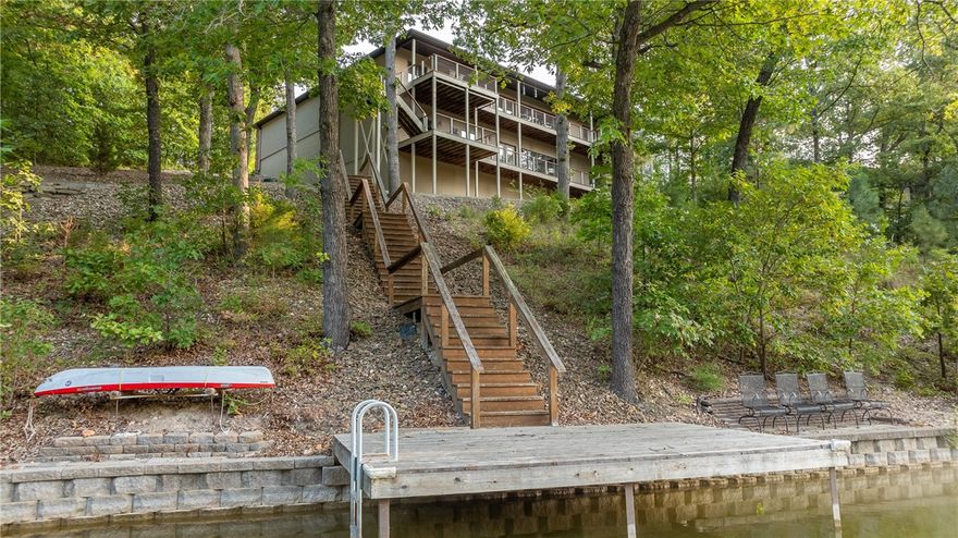 Welcome to beloved Lake Loch Lomond, a member's only lake in the heart of Bella Vista. This custom built home completed in 2013 by O.A.K. was lightly used as a weekend getaway and is offered furnished. The private 1 acre is gently sloped and offers a paved cart path to the dock. The rock landscaped yard is zero maintenance and features beautiful hardwoods. This home offers plenty of space with 3,657 SF, four bedrooms (two are master suites), four full bathrooms, upstairs and downstairs living rooms, and two bonus rooms used as an office and an extra guest room. The open concept kitchen is ideal for entertaining as are the covered double decks featuring wonderful lake views. There is plenty of storage inside and in the extra large two car garage. As a Bella Vista POA member, you can enjoy the miles of trails, six golf courses, tennis, swimming pools and social events. Only 14 miles to downtown Bentonville.