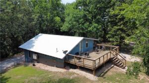 If you're looking for a private, peaceful getaway nestled in the woods of Eureka Springs this property checks all the boxes! Amazing lake area cabin with a stunning view of Beaver Lake. Sits on 1.87 acres with two amazing firepit locations. There is an expansive deck and a separate patio to lounge or grill. A separate shed for storage of all your lake accessories. Large floor to ceiling windows for lots of natural light. Two large size living areas, full size kitchen, large open dining area, space for full size washer and dryer. A roomy full size bathroom. This property comes with access to the Glenn Acres Property Associations private lake area. Don't miss out this lovely unique and incredible property! All furnishings are negotiable.