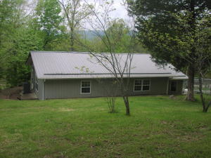 Nice cozy home with a metal roof on 20 pretty acres. Just a mile off of pavement yet has a very secluded feel. Large living room and kitchen. Big, new 40 X 60 metal building and a smaller one too plus another shed! Rural water and electric. 2x8 studded walls and extra insulation. Walk in closet and newer heat pump. Central air and heat with propane backup. Nice views from the home.