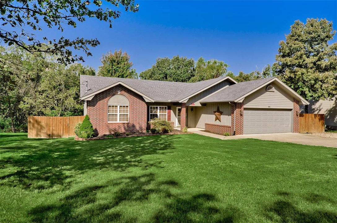 Pride of ownership shows in this awesome home! Desired East side location, fabulous large fenced yard. Many updates including wood flooring, kitchen counters, backsplash, paint, enlarged multi-level deck and more! Third bedroom with double doors could be office/study or bedroom. There is no carpet in the home, great for allergies. On sewer. Fridge, washer and dryer convey with accepted offer! Ready to move in and enjoy life in beautiful Bella Vista!