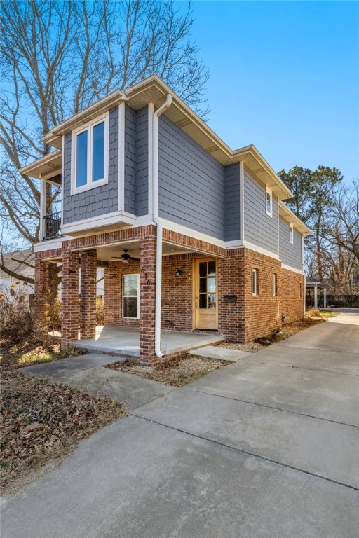 Experience Downtown Rogers living in this charming home located in a historic neighborhood. This 3 bedroom, 2.5 bathroom residence exudes modern luxury with historic appeal. An inviting porch will welcome you to the home, ideal for relaxing with a cup of coffee or enjoying the vibrant neighborhood atmosphere. The exterior boasts a detached garage for additional storage space. Inside, discover a thoughtfully designed interior with natural light from numerous windows. The heart of the home is the eat-in kitchen boasting an expansive island with gleaming countertops. The living area features a captivating brick fireplace with bricks used from a historic Rogers building. Upstairs, 3 well-appointed bedrooms offer privacy and comfort. One of the many highlights of the home are the various outdoor spaces, including a balcony, large porch, and detached garage. With its central location in Downtown Rogers, enjoy easy access to local amenities, dining, and entertainment! Carport was designed to easily convert to garage.