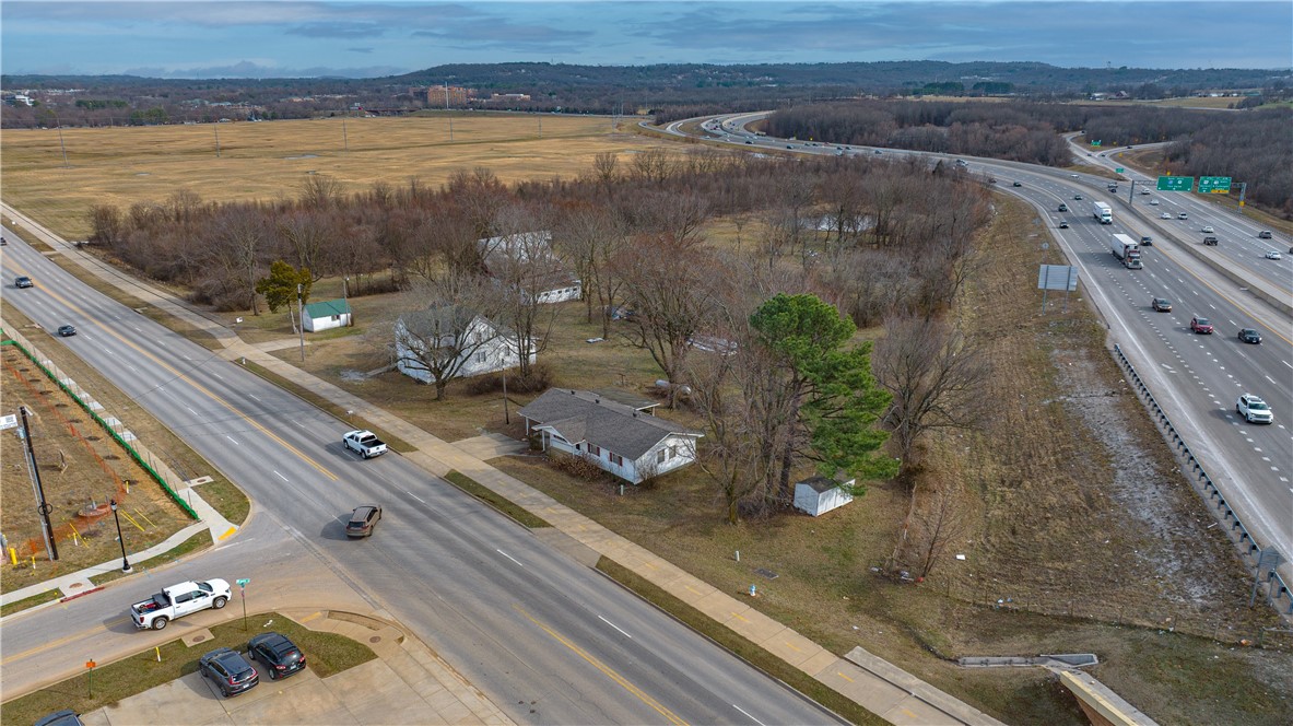 Commercial property with I-49 visibility fronting Van Ache Drive in Fayetteville. Capitalize on enormous growth in this area. Zoned R-A currently, however future land use suggest Urban Center. Bordering property all zoned C-2. Call agent for more information.