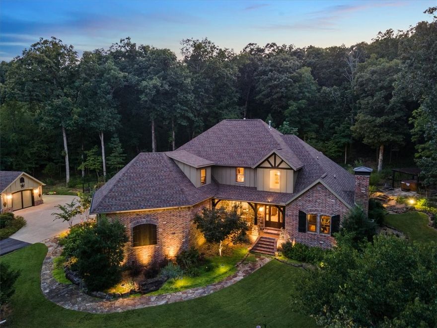 Custom built estate home, sitting atop a meticulously landscaped 5 acres in east Fayetteville. Seclusion at its finest, stationed just 18 minutes from the Fayetteville Square and less than 5 minutes from the White River. Step inside this clean, like-new home to beautiful hickory floors, new appliances, and fresh paint just to name a few. Gourmet kitchen with eat in area and hearth room. Elegant office with built-ins and fire place. Oversized closets in every room and wired for sound inside and out. Venture outside to a park-like setting that is overwhelmed with character. From the various fruit trees including apricot, pear, plumb and fig, to the fenced in garden that consists of (8) 10x4 stone raised beds. Set out for morning hike on your private trail that traverses 55 feet in elevation change, covers nearly 4/10 of a mile in distance and is crawling with wildlife. Detached garage has lots of options but makes for a great workshop and storage area. A truly unique property that you have to see to appreciate!