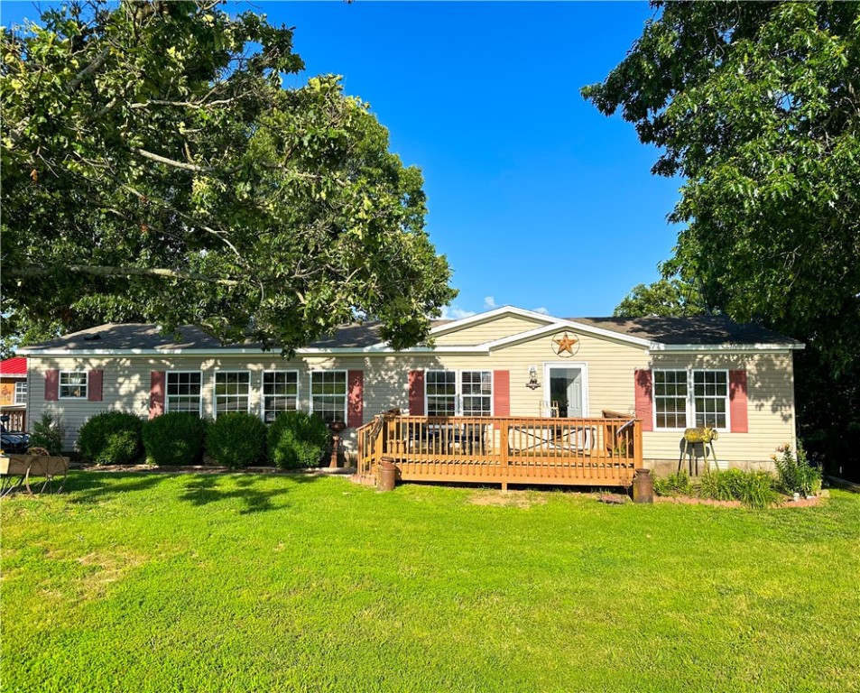 1,560 sq ft double-wide on permanent foundation, nestled on approx. 1.5 acres (subject to new survey—more land available if desired). Just 1.3 miles from the lake and a popular fishing tournament meetup spot & 4 miles from the popular chuckwagon races! Enjoy Ozark Mountain views, mature trees, and abundant wildlife. Perfect for a homestead or vacation retreat, with 3 levels of garden beds, a custom chicken coop (ceiling fan, heat lamps, nesting boxes, feed/equipment storage & MORE!), 2-stall horse corral, and a storage shed with new flooring freshly sealed. Peaceful setting with room to grow, raise animals, and enjoy nature. A rare mix of rural charm and functionality!