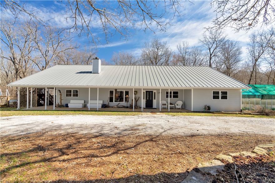 Fantastic home & shop in move-in condition situated on 2.65 acres with woods to the rear.  You have 2 greenhouses (with misters, heaters, air conditioning &  shade cloth); an above ground pool with new pump, filter, liner, & cover. Your home offers light filled open spaces for living & dining, an updated kitchen with stainless appliances (new electric oven, new washer & dryer) & luxury cabinetry.  Quartz surfaces, a custom pantry & abundant storage make this kitchen perfect for the serious cook. Your  large shop (37.7' x 50")  has solar panels for power; heat & air; two "high bay" garage doors & concrete flooring.  Four bedrooms ( one now used as an office) with a very comfortable primary suite & 3.5 baths makes family living easy & comfortable.  Upstairs you find a sitting area plus a separate game area which can accommodate a pool table.  There is also a "flex" room  for office/crafts. Producing pear, cherry trees & native plants on your land. Priced below appraisal, this home offers the best of country living.