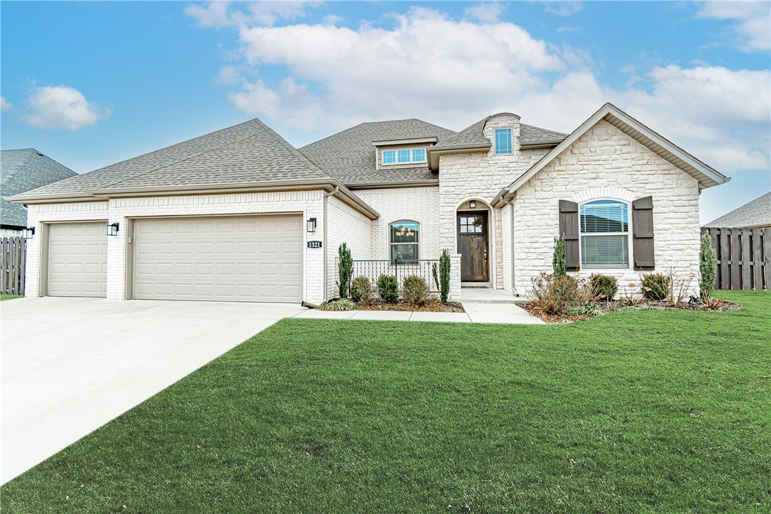 Stunning Centerton home with a great layout. This spacious home features an open concept floor plan with a bright and airy formal dining space and living area that flows into the top of the line eat-in kitchen. Features include vaulted ceilings, gas range, oversized 12ft island, stone fireplace, and built-in shelving. Relax in the spacious master suite complete with an ensuite bathroom boasting a double vanity, tiled walk-in shower, soaking tub, and large walk-in closet that goes into the utility room. The outdoor space is ideal for entertaining with its fenced backyard featuring a covered patio complete with additional fireplace, tv hookup, extended pergola, and ceiling fan. Extra features include front yard sprinkling system, custom storage shelving in the attic, pull outs in cabinets, and a 3 car garage. Community amenities include clubhouse, fitness center, pool, and more! Welcome home!