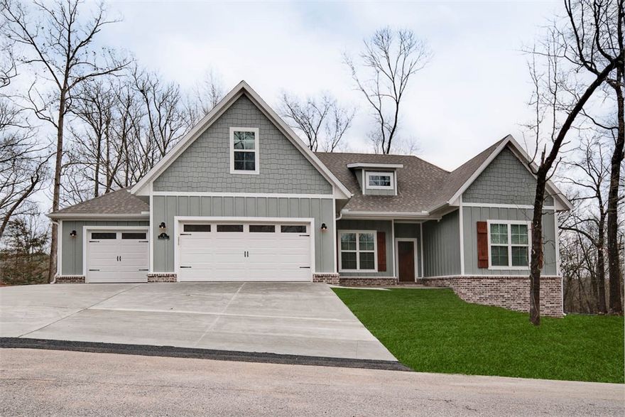 Check out this stunning new construction home on a FLAT .54-acre wooded lot! 3 car oversized garage! With 4 bedrooms and a bonus room complete with a full bath, there's plenty of space for everyone. The vaulted living room features beautiful beams and elegant wood floors, adding to the home's charm. The kitchen showcases a waterfall island, custom cabinets, premium black stainless steel appliances, a gas range, and 3 cm quartz countertops. Retreat to the primary bath, which offers a luxurious large walk-in tile shower, a free-standing tub, and generous closet space. Huge covered back patio! Quick access to I-49, Lake Loch Lomond, Highlands Golf Course, and Branchwood Recreation Complex and Nature Trail. This home perfectly balances tranquility and accessibility. Plus, take advantage of $3,500 in buyers closing costs, courtesy of the builder's preferred lender!