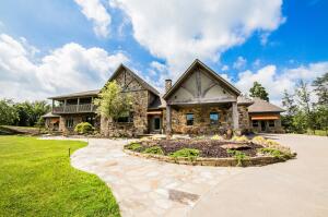 A Naturalist's delight! Elevated in the curve of Red Lick Mountain, on a ridge in the shadows of the Ozark National Forest, lays 28 acres with neighboring berry orchards. Mountain bike trails and whitewater rafting nearby, make this property easily used as a private residence, a personal or corporate retreat, or business venue. The main lodge is tucked into the hilly landscape, standing on solid rock and composed of an ICF foundation that includes radiant heat flooring on the basement level. The ground level features a gourmet kitchen and dining area, a boutique-size spa, lounge, and sitting room. Spa amenities boast indoor heated gunite pool with swim jet, separate wet and dry steam saunas, a freestanding air tub, and separate walk-in shower. Cedar closets are throughout.