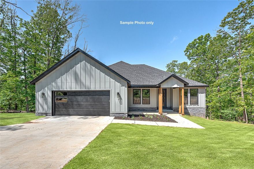 Stunning Modern Luxury Home with Breathtaking Ozark Views! Welcome to this exceptional single-story home, perfectly nestled on a quiet cul-de-sac w/ serene views. Designed w/ elegance & functionality in mind. Soaring cathedral ceilings & premium finishes throughout—no detail has been overlooked & no expense spared. Step inside to find Luxury Vinyl Plank flooring that flows seamlessly across the spacious layout. The great room is filled w/ natural light from oversized windows that showcase the beautiful Ozarks. The kitchen is an entertainer’s dream, featuring a massive island, quartz, custom cabinetry &walk-in pantry. 3 bdrms, 2.5 bthrms, + an Office w/ built-ins. The primary suite is tucked away in it's own private wing; spa-like bathroom w/ a soaking tub & custom shower w/ full tile accent wall. Enjoy a large covered deck perfect for relaxing or entertaining. Oversized two-car garage. This home truly has it all: style, comfort, & views.