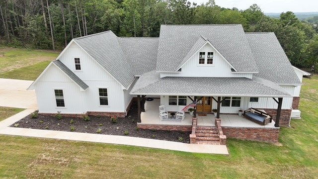 Contemporary Elegance Meets Country Charm in this beautiful 4-bed, 3-bath custom home, where upscale finishes meet the peace and charm of country living. Perched atop Crow Mountain, this like-new home offers 3,189 sq ft of heated/cooled living space. Thoughtfully designed you will enjoy mountain views and a quiet, friendly neighborhood, just 7 minutes from Atkins and 15 minutes to Russellville. The open-concept floor plan has abundant natural, LED light, gourmet kitchen, high-end appliances, custom cabinetry, farmhouse sink & walk-in pantry. The primary suite has walk-in shower, acrylic tub & 2 walk-in closets secluded from kids/guests with a thoughtfully designed split floor plan. Foam-sprayed exterior walls, propane for cooking, Jack & Jill bathroom w/ walk-in closets. Dedicated office/fourth bedroom w/ attached full bath, large laundry room, security cameras, expansive front & rear porches, 3-car garage, & 27kW Generac generator. Move-in ready, built to the highest standards, call for your private showing today!