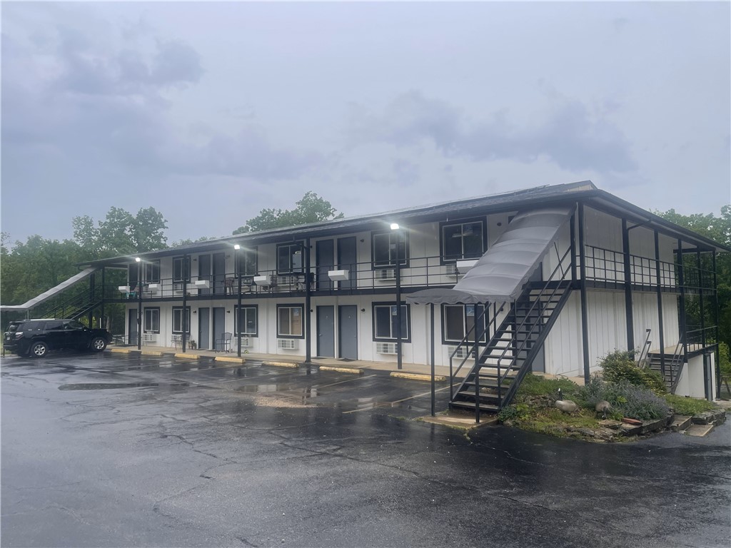 Exceptional Investment Opportunity in Holiday Island, AR
Unlock the potential of this commercial property offering multiple income streams. Located in a growing resort community, it includes two major features:
1. Hotel-to-Multifamily Conversion: A 10,500 sq.ft. building, originally a 30-room hotel, is being transformed into 24 studio and 1-bedroom units, with 11 already completed and rented. Ideal for short or long-term rental income.
2. Turnkey Restaurant & Bar: A 4,338 sq.ft. fully equipped restaurant with a commercial kitchen, dining area, and bar. It includes an 832 sq.ft. outdoor deck for events or expanded seating.
Above the restaurant is a 2-bedroom, 1-bath apartment for owner use or additional rental income. Both buildings are on a single tax parcel, simplifying management. This property offers incredible versatility and upside in a thriving destination.