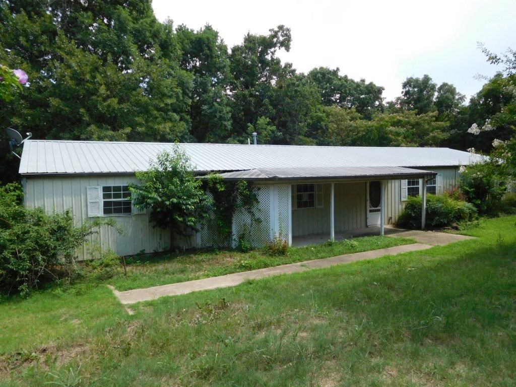Custom designed home with metal roof and siding. Located just East of Lincoln on 9.2(+/-) AC. Large covered back porch with deck area & gazebo, creek runs through back of property. Split floor plan with large and open living area. This is a Fannie Mae Property.