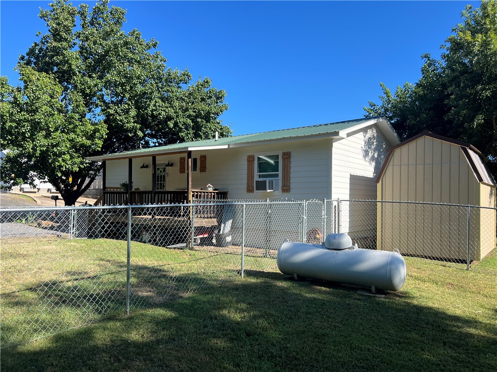 Charming 2-bedroom, 1.5-bath home located at 103 Lynn St., Marshall, AR 72650, featuring a spacious 16x30 workshop that could be converted into additional living space or a game room, plus an 8x12 storage building for extra storage. The home and 16x30 building are heated and cooled by ductless mini splits. The covered deck overlooks the spacious yard with two chain-link fenced areas, perfect for pets or children to play safely. Conveniently located within walking distance to the city park, fishing pond, grade school, library, and courthouse square, and just 15 minutes from the Buffalo National River for kayaking, hiking, and outdoor recreation, this property would make a great full-time residence, rental, or VRBO investment.