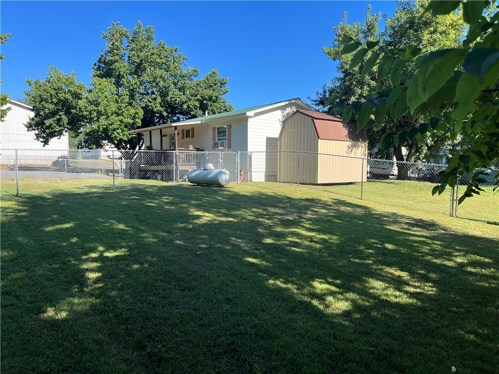 Charming 2-bedroom, 1.5-bath home located at 103 Lynn St., Marshall, AR 72650, featuring a spacious 16x30 workshop that could be converted into additional living space or a game room, plus an 8x12 storage building for extra storage. The home and 16x30 building are heated and cooled by ductless mini splits. The covered deck overlooks the spacious yard with two chain-link fenced areas, perfect for pets or children to play safely. Conveniently located within walking distance to the city park, fishing pond, grade school, library, and courthouse square, and just 15 minutes from the Buffalo National River for kayaking, hiking, and outdoor recreation, this property would make a great full-time residence, rental, or VRBO investment.