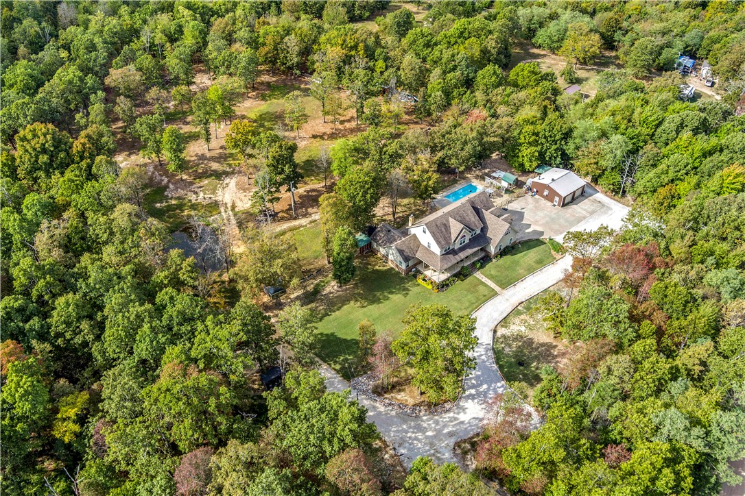 This is not just a home, its a life style! In these times we are working, living, and playing in our own space more than ever. This home offers the satisfaction of spreading out. Spread out amongst the ample rooms of the home. Spread out on the 5 acres with a pond and mini farm or just a picnic at the pool. Spread out to the shop with finished office and Fiber internet. The first floor has ample amenities to enjoy life. Just imagine the laughs and delicious meals spilling out of the open kitchen into the welcoming family room. Tucking all the littles into bed on the second floor, and having everyone piled into the third floor bonus room for a movie. The amenities brochure is a must see. This home offers more than I can fit into this description. Skyview West will be paved in Spring 2022. Small barn in the field has a tack room and feeding stalls. Second Master, second laundry, and second bonus room on second floor. Third floor is bonus room/ bedroom.