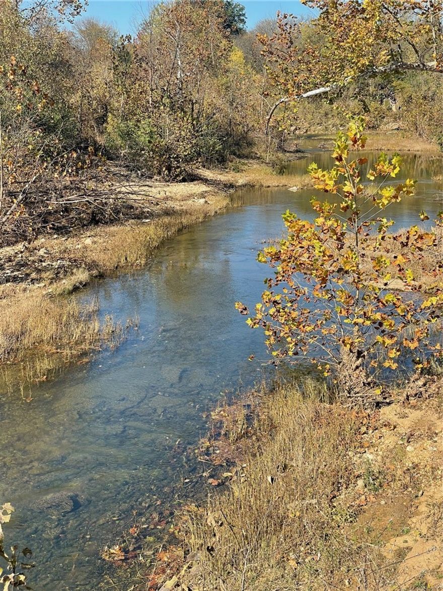 Great opportunity to purchase 10 acres m/l with Osage Creek and Hwy frontage.   Fenced on 3 sides with mostly pasture. No water well is on this property. You will need to drill a new well. Excellent place to build a Home and have a few animals close to town.