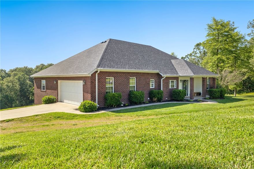 Perched atop a picturesque ridge minutes from Huntsville and only ~30 minutes to Springdale/Fayetteville, this home offers a rare blend of privacy, space, and scenic elevation—without remote isolation. The main floor’s light-filled living areas are ideal for relaxed evenings or entertaining, and the expansive deck captures sweeping valley views. Downstairs, the finished walk-out basement is now a home gym but easily converts to a media room, playroom, guest suite, or in-law space. Built in 2008 with a new roof and HVAC in 2023, this home combines quality with ease of ownership. On just over five acres, the natural terrain offers low-maintenance living and a true hillside sanctuary—no flat-lot upkeep, just your private retreat. Whether sipping morning coffee on the deck, entertaining under the stars, or enjoying the open lower level, this home is built for meaningful living and memorable moments. Recently appraised near $600,000, it offers instant equity and an exceptional location. View the 3D Matterport tour!