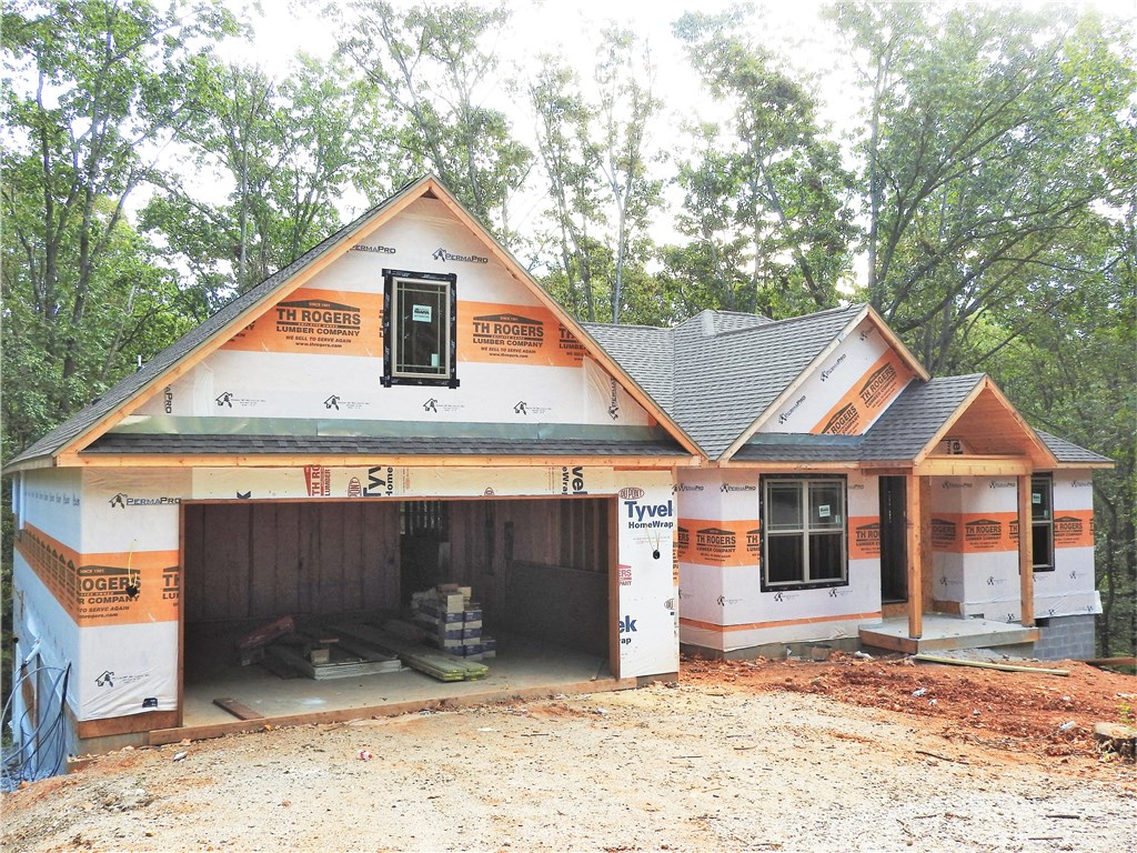 This home is a must see. Incredible Custom built 5 bedrooms 4.5 baths. High ceilings and lots of windows bring lots of light. Two covered decks upper and lower backing to the forest. Upstairs you will find an open concept floor- plan for all your entertainment needs. Down stairs is another open area with work shop with out side entry. two more bedrooms, family room wet bar, and two bathrooms. Safe room is on lower level. Very private setting. Perfect for large family.