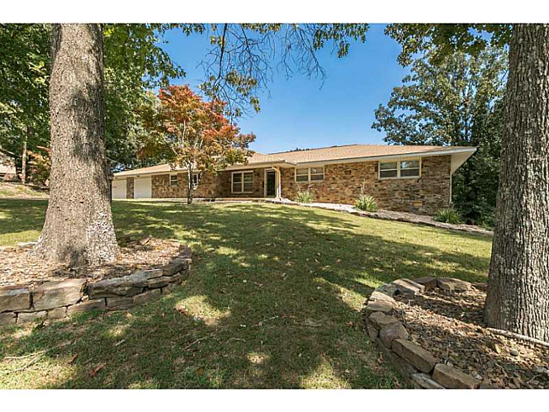 Stunning beautiful remodeled & redecorated home on 3/4 acre lot w / view of Beaver Lake. Open floor plan w/ huge sunroom currently used as office. 2 FP's, new oak floors, new kitchen w /new lighting, plantation shutters, new carpet in bedrooms, guest,quarters / 4th bedroom off garage. New light fixtures thru out house. Roof new 2015. Whole house generator. Storm shelter, sprinkler system. Near public boat launch. So much more. New knotty Alder cabinets. Storm shelter in garage. 2 fireplaces.