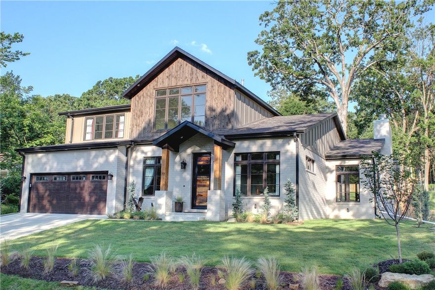 Custom built home with careful attention to detail just two blocks from the University of Arkansas football stadium.  Kitchen, living and dining open design with hardwood floors throughout the home.  High end appliances, custom cabinetry, gas range, wood windows, game room upstairs, master suite and additional bedroom located on the main level along with a separate office.  Large covered back patio accessed through oversized double glass doors.