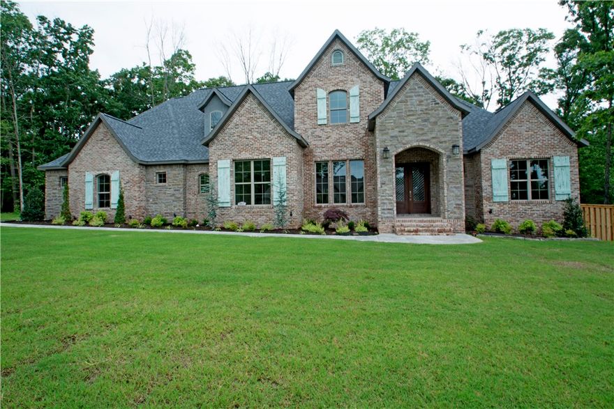 JSN Properties home featuring reclaimed brick exterior & 4 car garage. Custom wood ceiling & brick arch in entry, 22 ft marble kitchen island, spa like master & downstairs media room with fireplace. This home is family friendly & perfect for entertaining. Lots of custom upgrades and a great layout truly make this the perfect home in a beautiful setting in Oak Tree! Bonus room upstairs w half bath. Fireplace in LR w custom brick surround and ship lap accents. See attached features sheet!