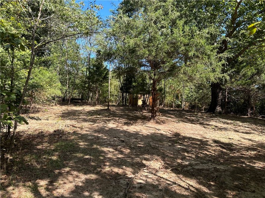 Beautiful partially wooded, level property with secluded mountain top views at 1850' elevation. This totally fenced 7.17 acre property has a large pond stocked with channel catfish, brim and bass. A perfect place to build a new home or move in a newer Manufactured home, with water, electric, septic system and fiber optics already existing.  The property has been used as a Air Soft field with 40+ water containers and 40-50 blue barrels set up throughout the property.  The water containers and barrels can be removed with an acceptable offer or they can remain for the new owners personal use. The seller will not remove the current manufactured home.  But it can be viewed with a two hour notice, since it is tenant occupied.