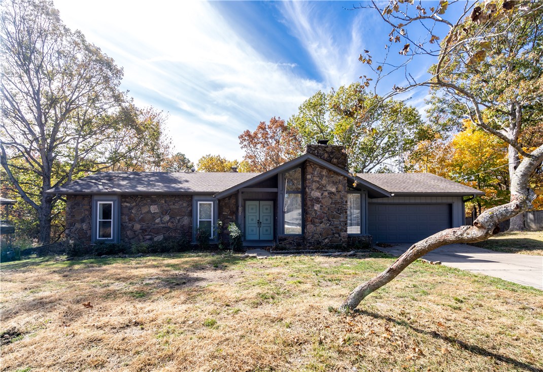 Well maintained home in the Prairie Creek area is close to Prairie Creek marina, park and boat ramp. A short drive to Downtown Rogers, Lake Atalanta, bike trails and restaurants. This 5 bedroom home is the perfect family home or weekend retreat. The home boasts a large covered patio and screened-in deck, 2 living spaces each with a fireplace, multiple built-ins and a flex room. The primary bedroom opens up to the deck, where you can enjoy your morning coffee overlooking the fenced yard with mature trees and wooded area behind. There are 3 bedrooms and 2 bathrooms upstairs with 2 bedrooms and a bath downstairs. This home is the perfect peaceful retreat from the hustle and bustle of the day. Located in an established neighborhood. Garage door replaced 2023.